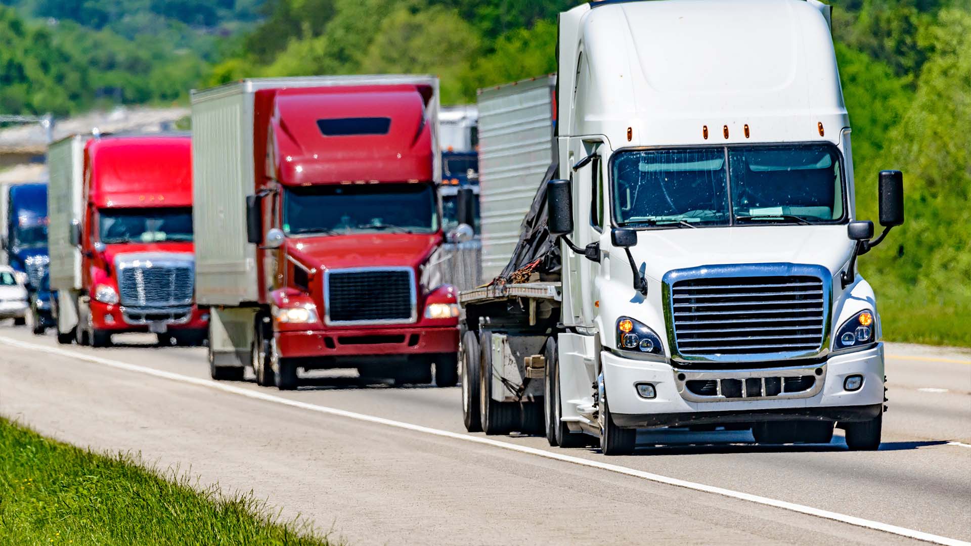 Oversize load semi truck hauling a large modular building on a public highway